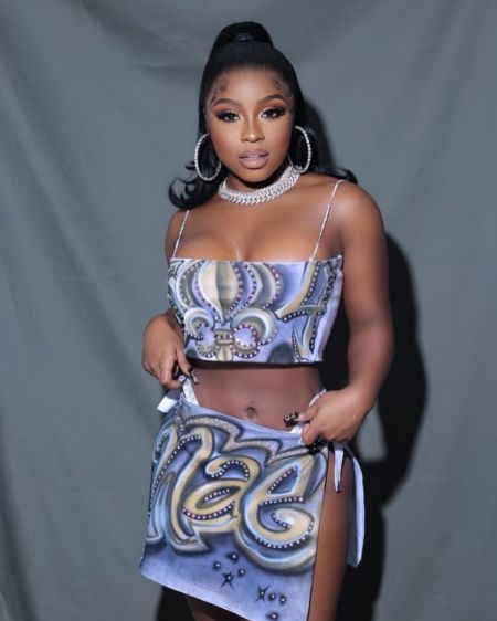 Reginae Carter in a gorgeous dress poses a picture.